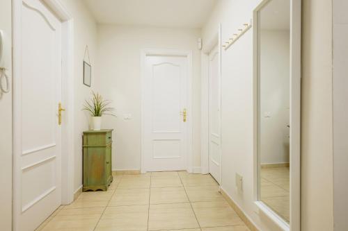 a hallway with white walls and a mirror at Cozzy Carolina III in Adeje