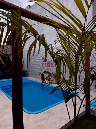 a plant in front of a swimming pool at Villa Oásis Espaço para eventos in Anápolis