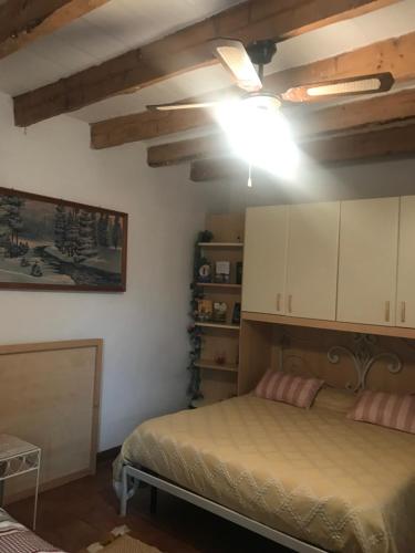 a bedroom with a bed and white cabinets at Old school Bacedasco B&B in Vernasca