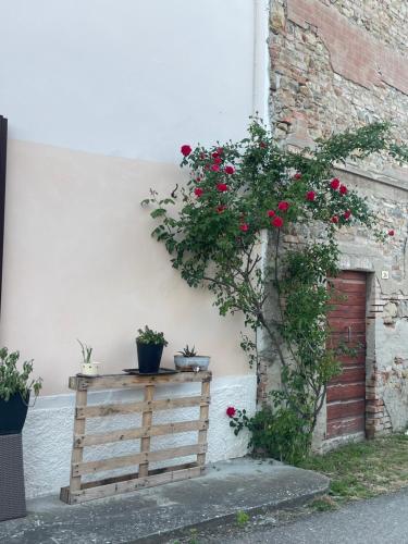 a wooden table with flowers on it next to a building at Old school Bacedasco B&B in Vernasca