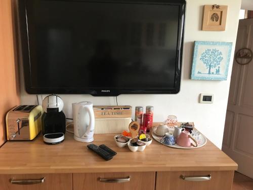 a television sitting on top of a wooden table with food at Old school Bacedasco B&B in Vernasca