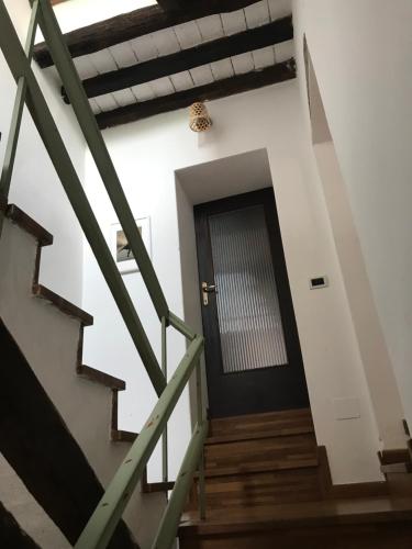 a staircase leading to a door in a building at Old school Bacedasco B&B in Vernasca
