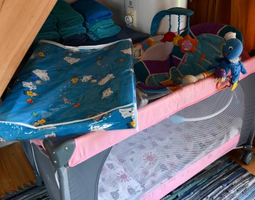 a childs bunk bed with a blanket and a crib at Villa Blue Heaven Pärnu in Pärnu