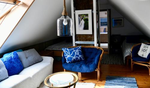 a living room with a couch and two chairs at Villa Blue Heaven Pärnu in Pärnu