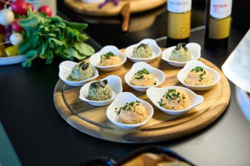 a tray of small dishes of food on a table at Henriette Stadthotel Vienna in Vienna