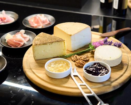 a plate of cheese and other foods on a table at Henriette Stadthotel Vienna in Vienna
