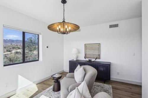 a living room with a couch and a chandelier at The Grand Horizon in Vail