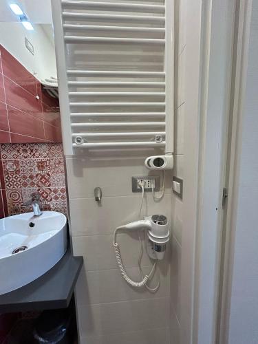 a small bathroom with a sink and a toilet at Rosso Relativo in Acilia