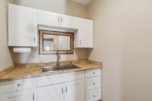 a kitchen with white cabinets and a sink at The Grand Horizon in Vail