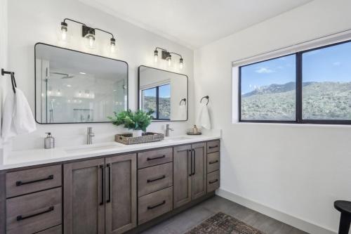 a bathroom with two sinks and two mirrors at The Grand Horizon in Vail