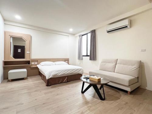 Postel nebo postele na pokoji v ubytování Cai Jyu B&B