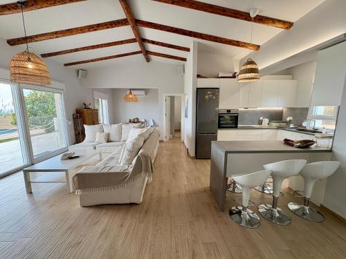 a living room with a couch and a table at Oceana - Exclusive Beachfront Villa with Private Pool and BBQ by GG in Alexandroupoli