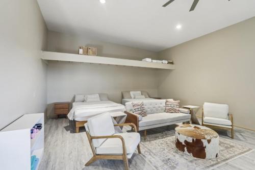 a room with two beds and a couch and chairs at The Grand Horizon in Vail
