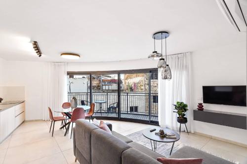 a living room with a couch and a table at Deluxe 1 Bedrooms Apartment Terrace in City Center in Jerusalem