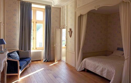 a bedroom with a bed and a chair and a window at Château d'Argoules, Baie de Somme près de la mer in Argoules