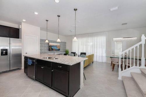 a kitchen with a counter top and a kitchen with a dining room at Luxurious Townhome in Solterra Resort - SOLT01 in Davenport