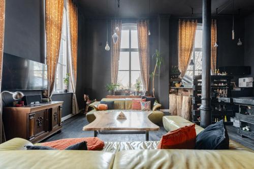 a living room with a couch and a table at Bahnhofsromantik trifft Luxus - Alter Bahnhof von Kruft in Kruft