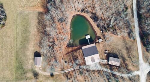 an overhead view of a barn and a lake at Winding Woods Lodge in Clinton