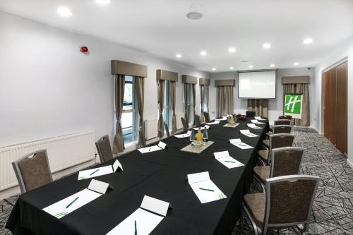 a conference room with a long table and chairs at Holiday Inn - Manchester - Oldham by IHG in Manchester