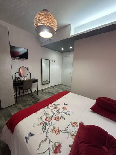 a bedroom with a large bed and a desk at Rosso Relativo in Acilia