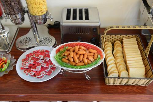 a table topped with plates of food and a bowl of food at Vientiane Luxury Hotel in Vientiane