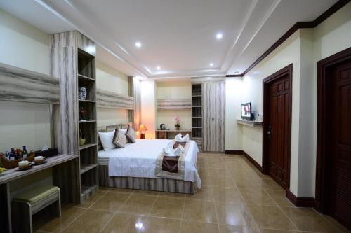 a bedroom with a bed and a desk in it at Vientiane Luxury Hotel in Vientiane