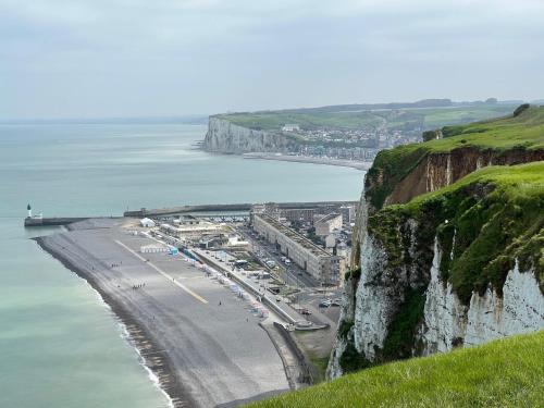 a view of a beach next to the ocean at Villa clair de Falaises in Le Tréport