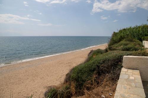 a sandy beach with the ocean in the background at Oceana - Exclusive Beachfront Villa with Private Pool and BBQ by GG in Alexandroupoli