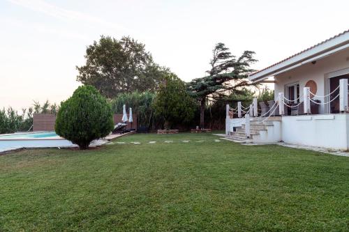a view of the yard of a house at Oceana - Exclusive Beachfront Villa with Private Pool and BBQ by GG in Alexandroupoli