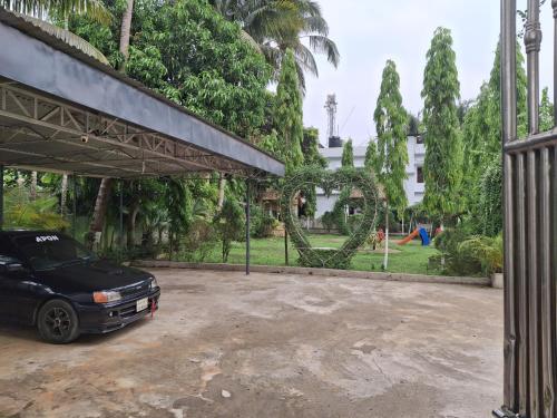 a car parked in a parking lot next to a playground at Green Park Tea Resort Sreemangal in Sreemangal