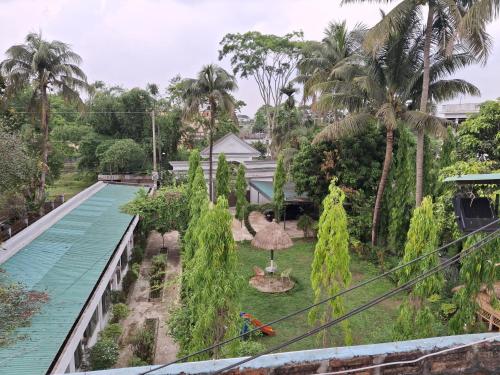 a view of the garden from the balcony of a house at Green Park Tea Resort Sreemangal in Sreemangal