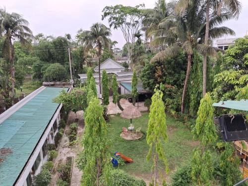 an aerial view of a resort with a swimming pool and palm trees at Green Park Tea Resort Sreemangal in Sreemangal