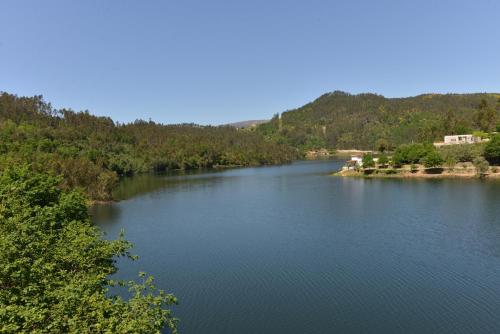 a view of a river with trees in the background at Casa do Vouga in Oliveira de Frades
