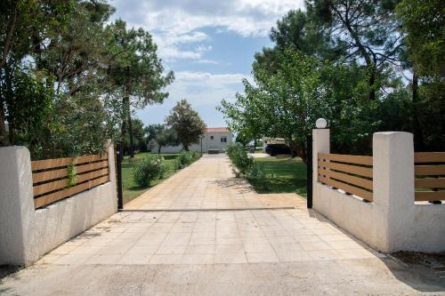 a walkway leading to a house with a fence at Oceana - Exclusive Beachfront Villa with Private Pool and BBQ by GG in Alexandroupoli