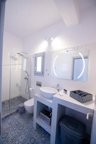 a bathroom with a sink and a toilet and a shower at DENIS Summer Living in Perivolos
