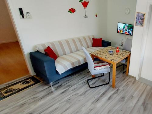 a living room with a couch and a table at Ema & Sea Apartment's in Pula