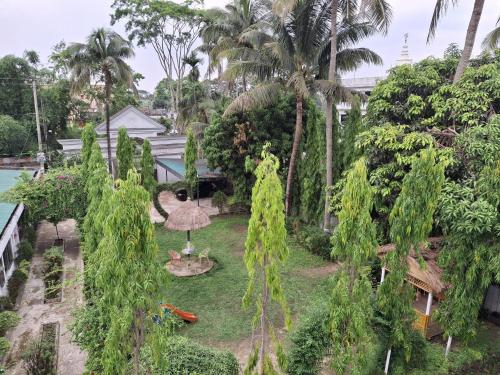 an aerial view of a garden with palm trees at Green Park Tea Resort Sreemangal in Sreemangal