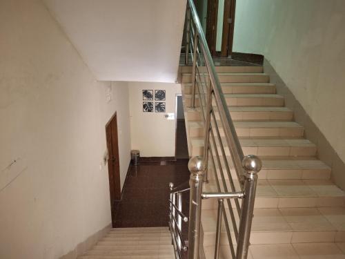 a staircase in a building with a metal railing at Green Park Tea Resort Sreemangal in Sreemangal