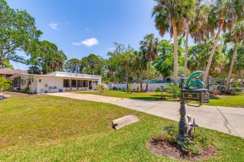 a house with palm trees and a yard at Hot Tub and Gas Grill Port Richey Retreat in Port Richey