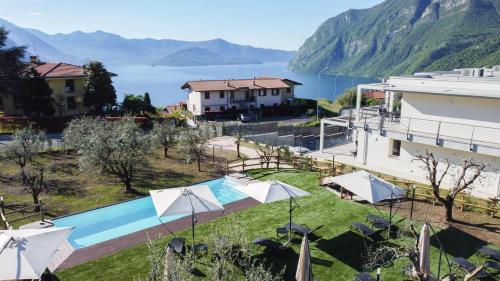 a resort with a pool and a view of the water at Costa Blu - Pool & terrace lake view in Riva di Solto