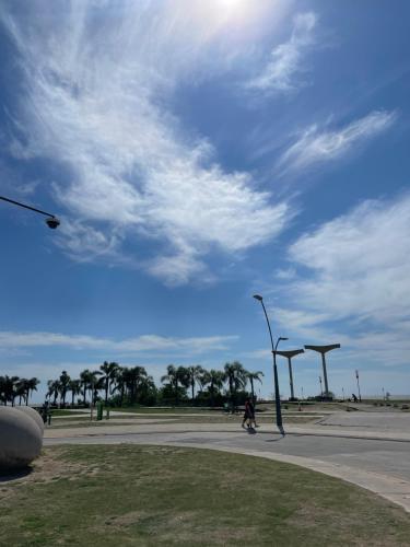 a person walking down a street with a street light at Hotel Vicente López in Vicente López