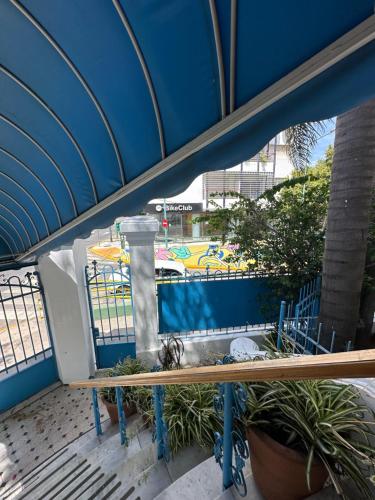 a balcony with a blue fence and plants at Hotel Vicente López in Vicente López