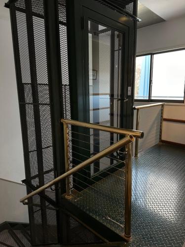 a staircase in an office building with a revolving door at Hotel Vicente López in Vicente López