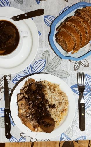 a table with a plate of food and a cup of coffee at Pueblo Nómade in Tranqueras