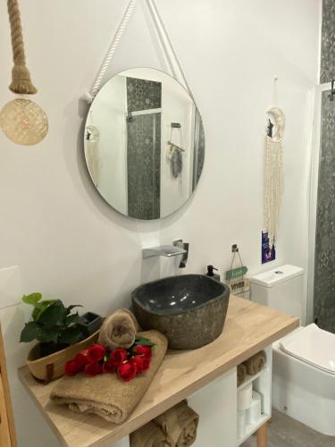 a bathroom with a sink and a mirror at Alto do Moinho in Alcobaça