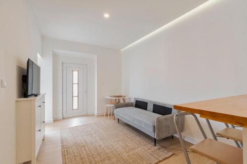 a living room with a couch and a table at Palmela Oásis Apartment I in Palmela
