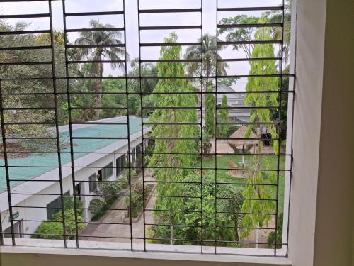 a window with a view of a pool at Green Park Tea Resort Sreemangal in Sreemangal