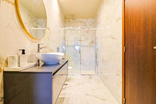 a bathroom with a sink and a shower at Casa Vale do Luar in Celorico de Basto