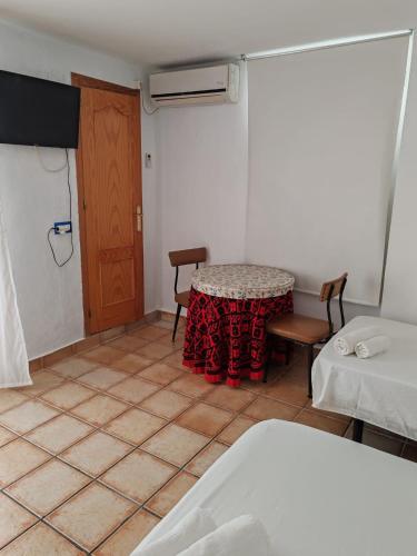 a room with a table and two chairs and a door at Casa Cabo de Gata in Retamar