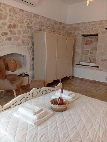 a living room with a bed and a fireplace at Tselekos House Old renovated stone house crete in Galiá